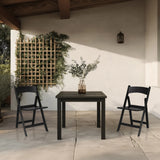 Zwei schwarze Outdoor-Stühle TRAVANO 1 mit passendem Tisch auf einer Terrasse von hjh LIVING